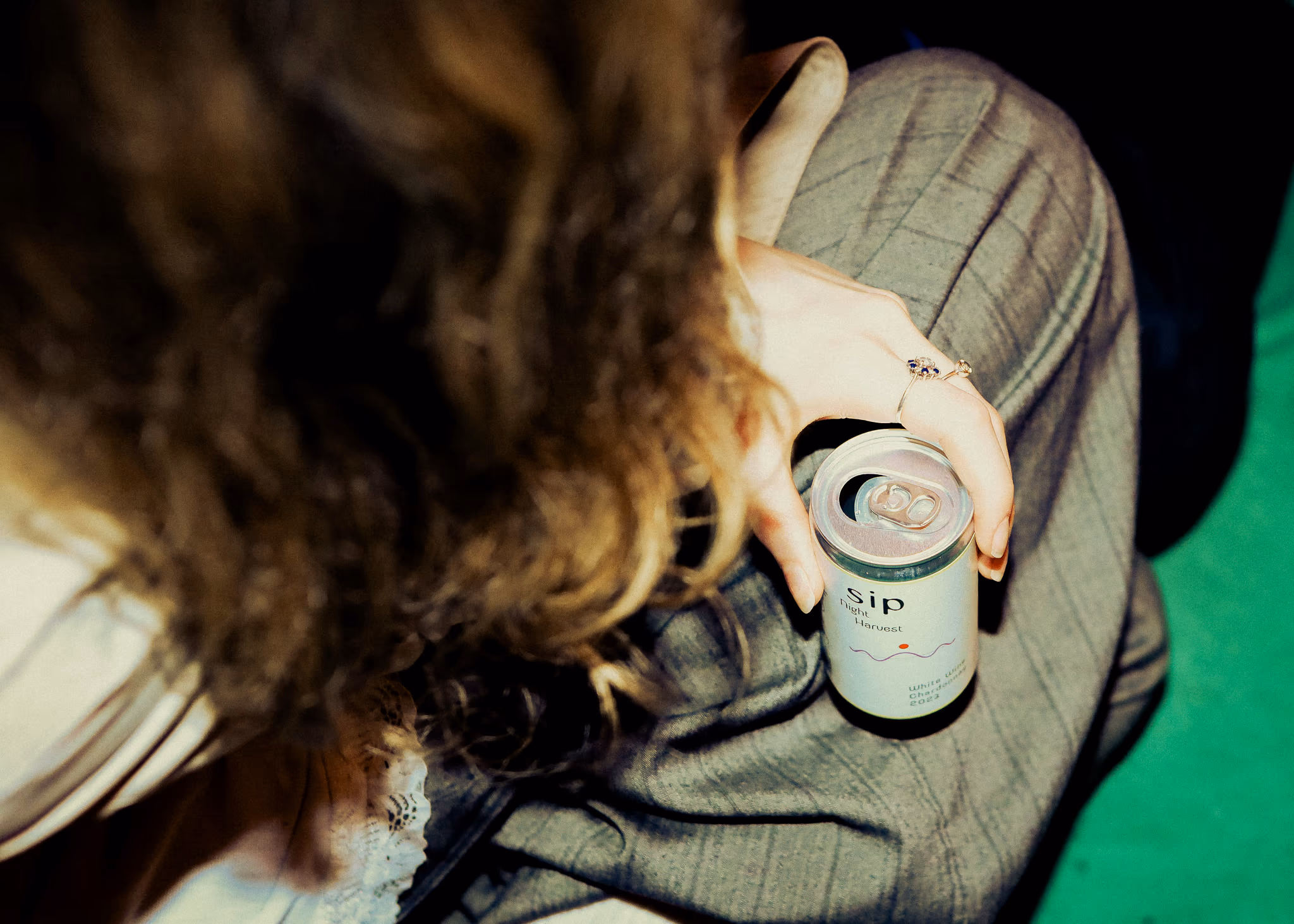 Overhead view of a SIP can held over jeans